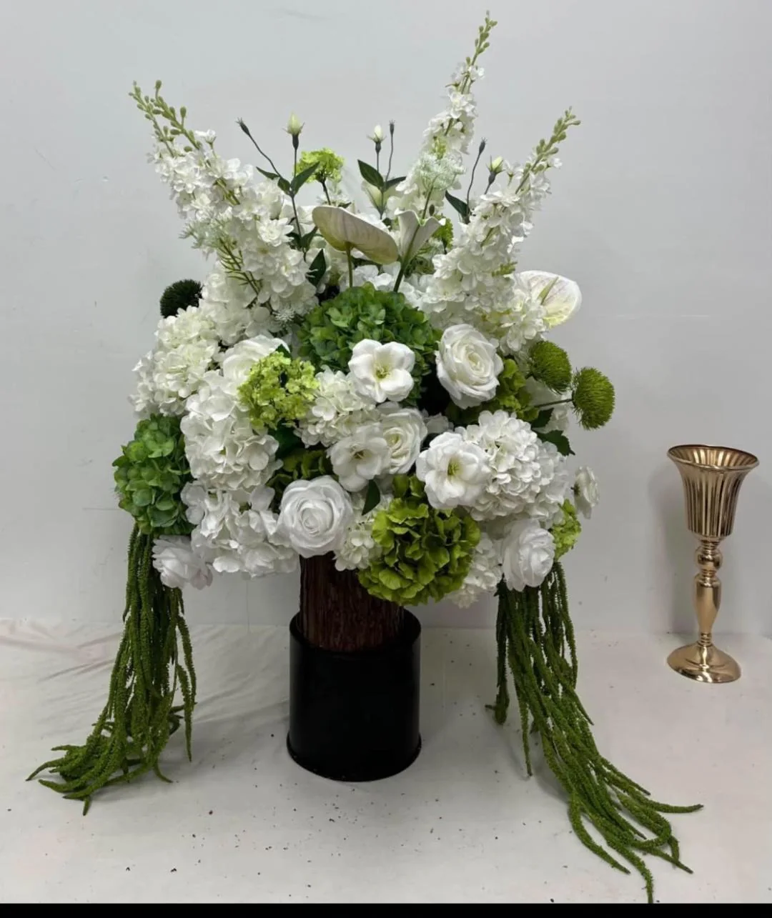 Ivory and sage wedding floral arrangement rental on dark pedestal OKC